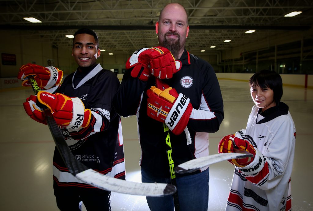 CALGARY.; JANUARY 07, 2016 -- Kevin Hodgson, director of operations for Hockey Reaching Out Society, middle, with Malik Walker,18, left, and Blaze Prairie Chicken, 12, at Ernie Starr Arena in Calgary. Photo by Leah Hennel, Calgary Herald For City story by Valerie Fortney